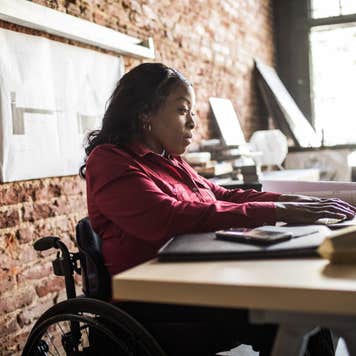 Businesswoman in wheelchair working at desk