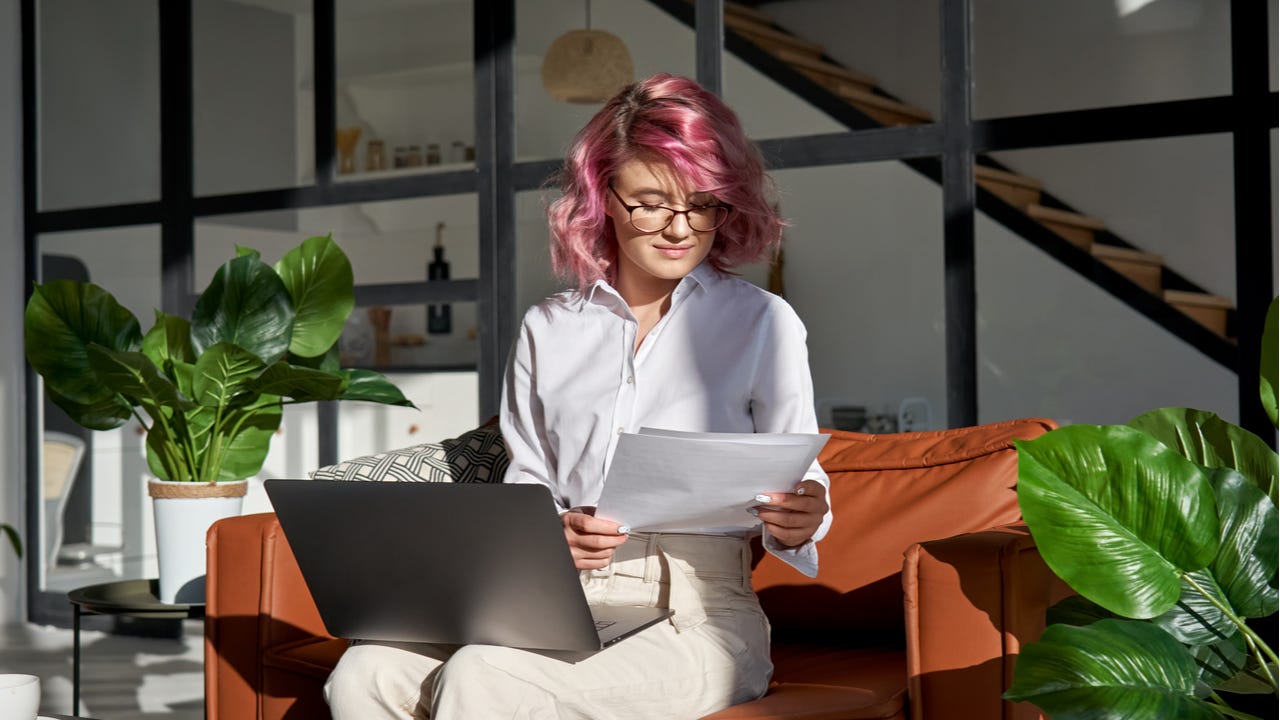 Young hipster woman reading paperwork