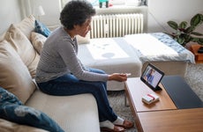 Senior woman on a video telemedicine call with a doctor at home