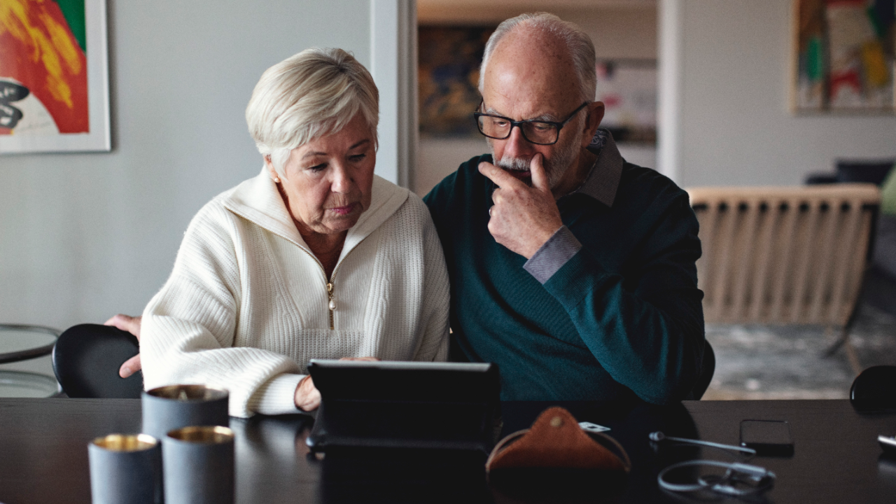 Senior couple works on iPad