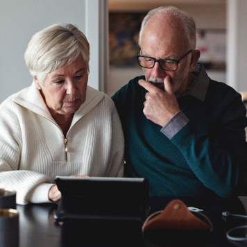 Senior couple works on iPad