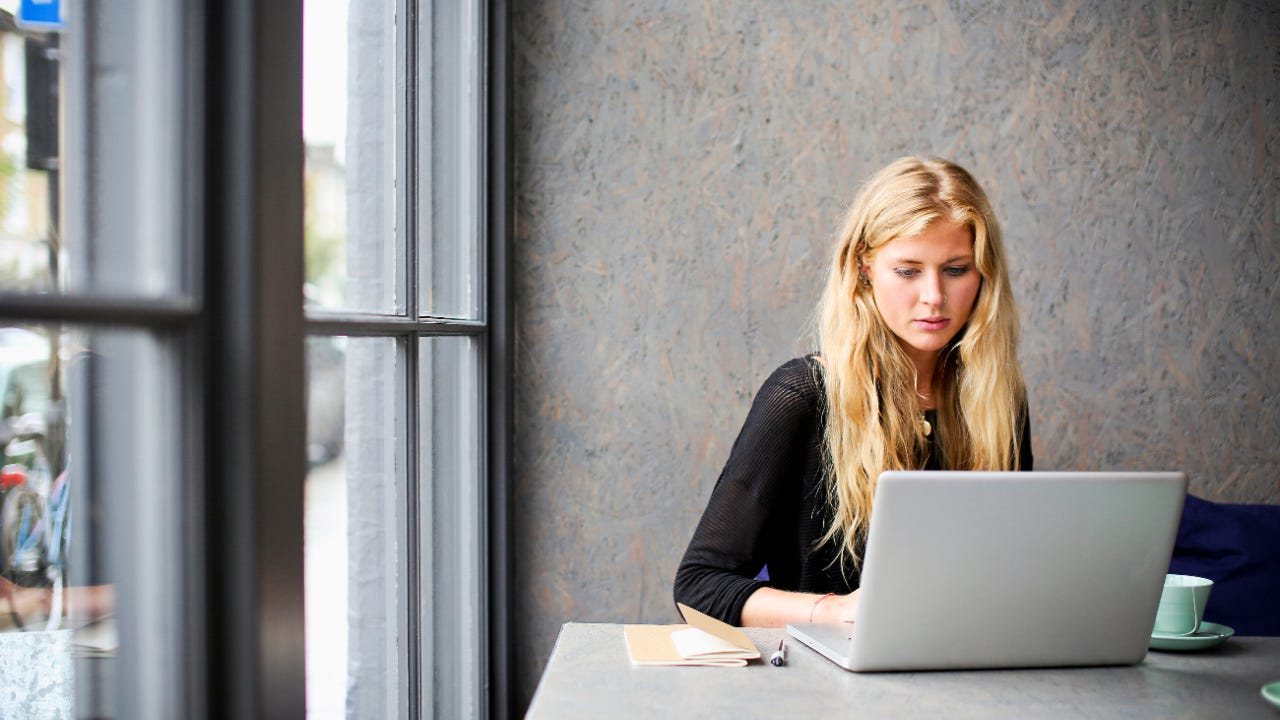 A picture of a young White woman using her laptop computer