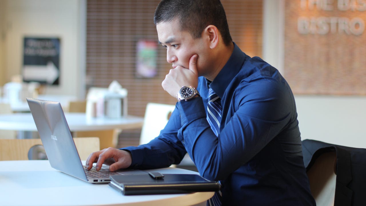 A man works on his laptop.