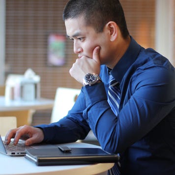 A man works on his laptop.
