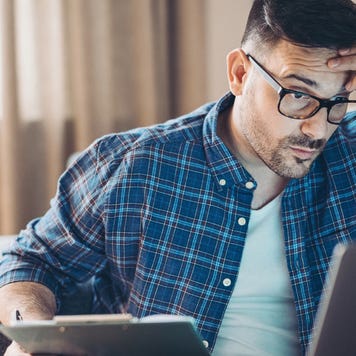 Confused young man working at home