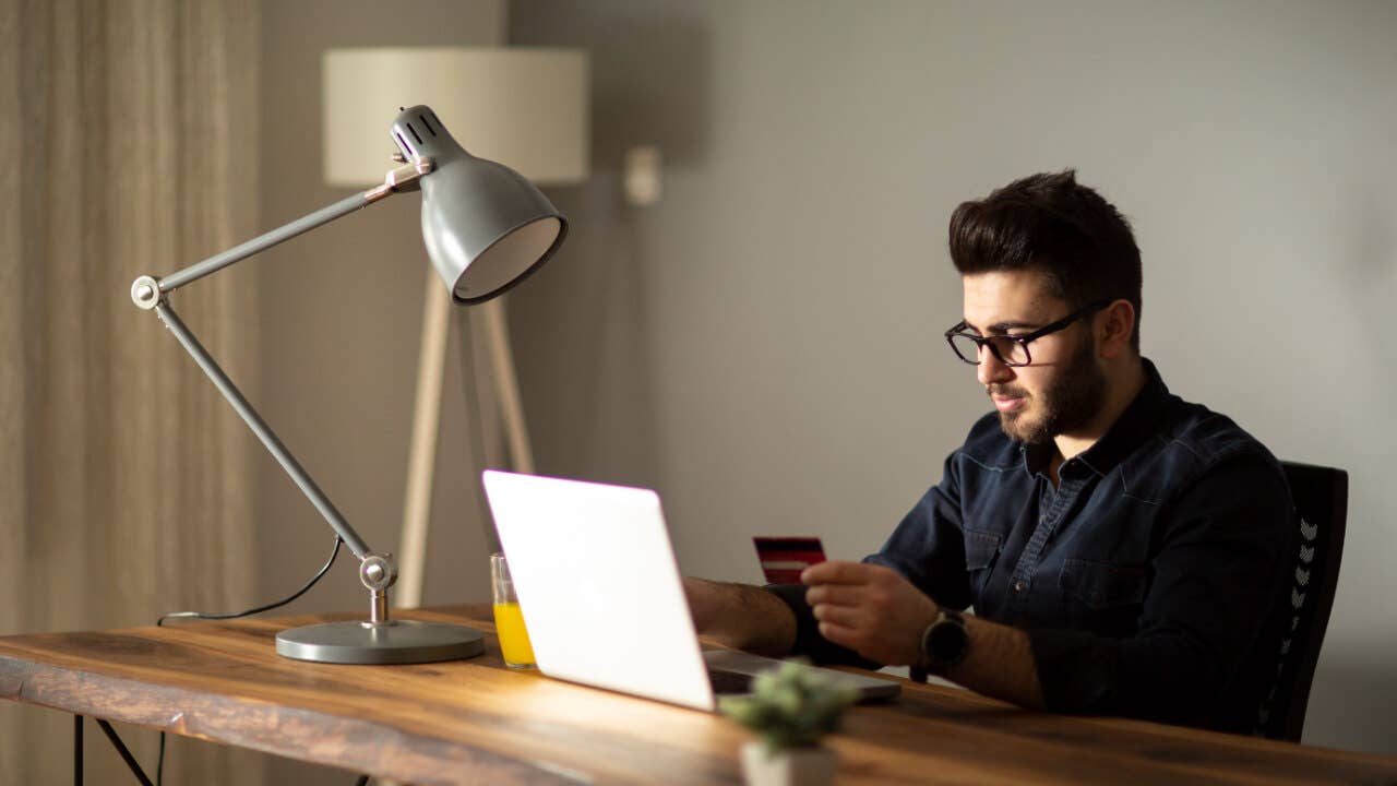 Man using credit card while online