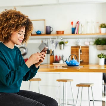 A young woman works on her smartphone.