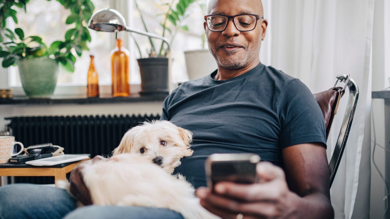 A senior man is on a smartphone.