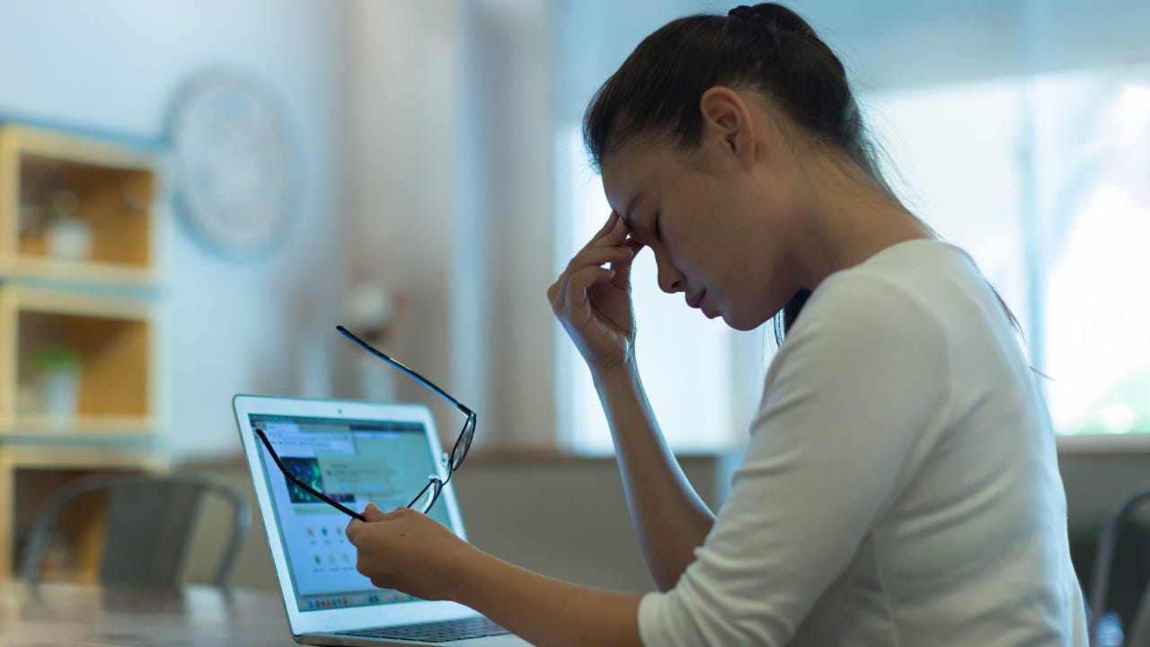 Tired stressed out woman working on her computer.