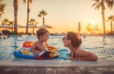 Mother with child in swimming pool at resort