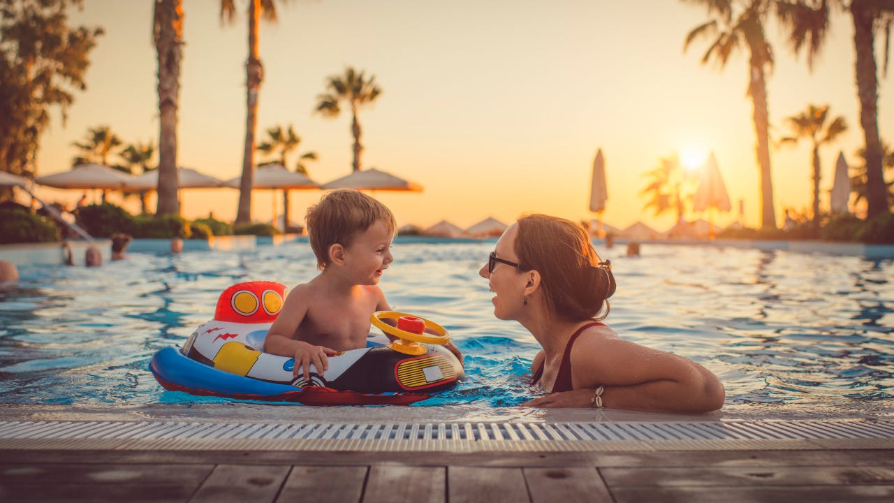 Mother with child in swimming pool at resort