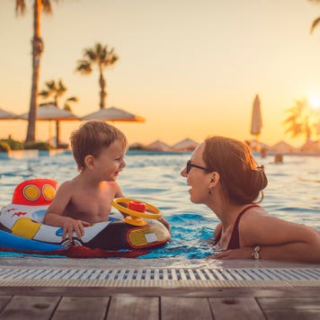 Mother with child in swimming pool at resort