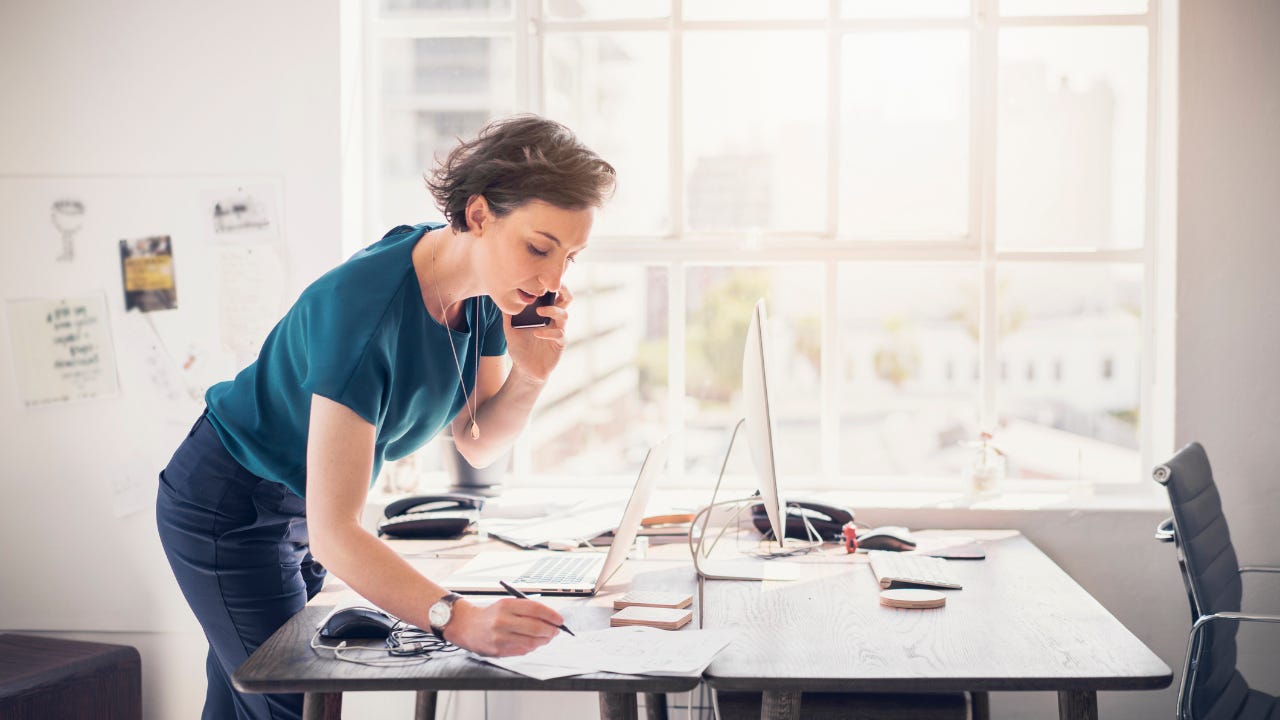 Businesswoman standing at desk