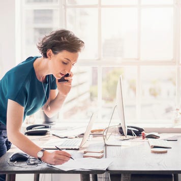 Businesswoman standing at desk