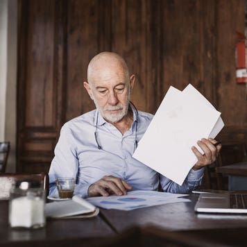 man looking through papers