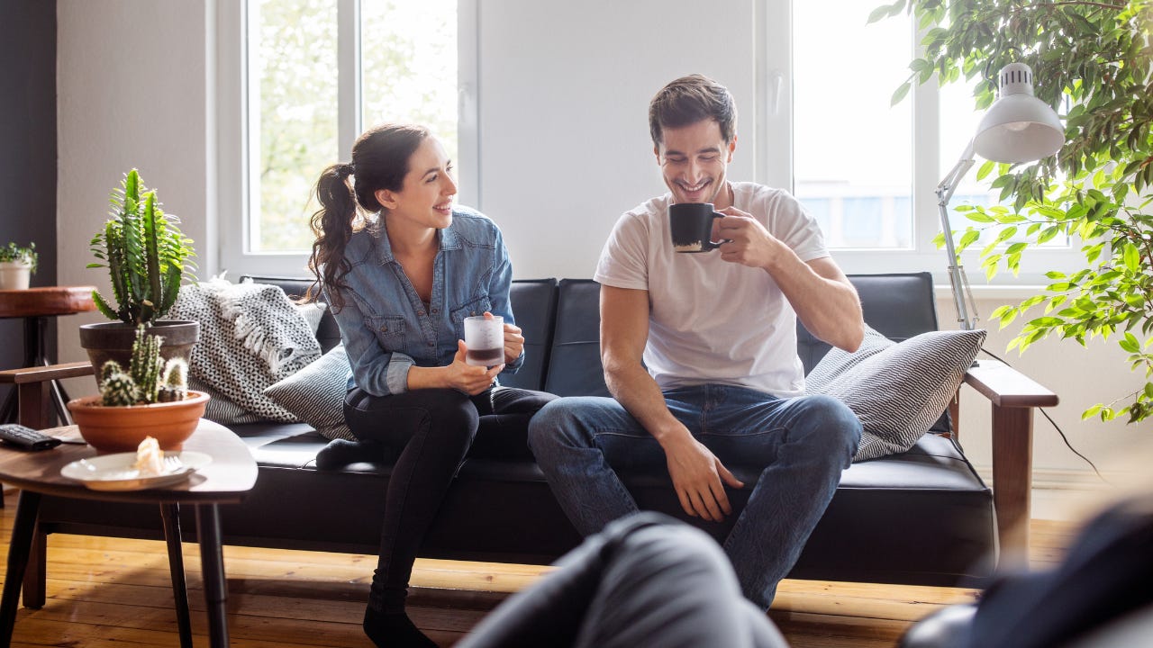 Group of friends relaxing together in living room