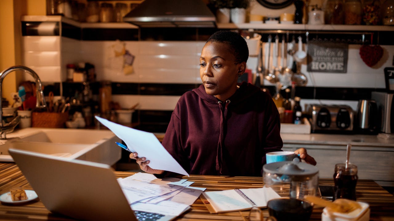 Young woman doing home finances in the evening
