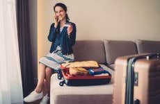 Woman with luggage in hotel