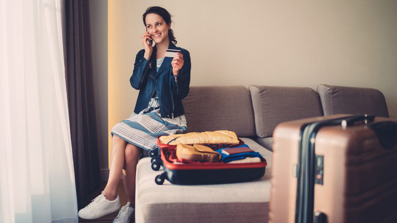 Woman with luggage in hotel