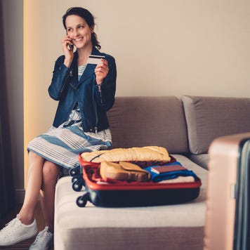Woman with luggage in hotel
