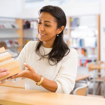 Librarian accepts book returns
