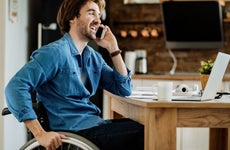 Young man working from home in a wheelchair