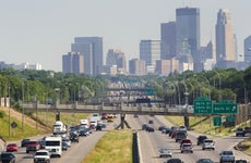 Busy Traffic on Multiple Lane Highway with Minneapolis, Minnesota Skyline