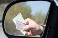 A Man shows Driver's License and Vehicle License during a Check