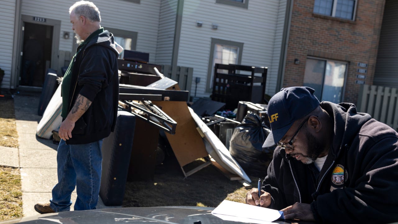 Deputy Service Bailiff Michael Taylor signs a writ of eviction in the unincorporated community of Galloway on March 3, 2021 west of Columbus, Ohio. Taylor says that he usually waits days past the deadline to clear out properties so there is not a confrontation.