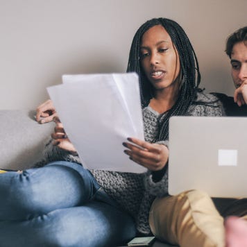 Young couple at home planning an investment