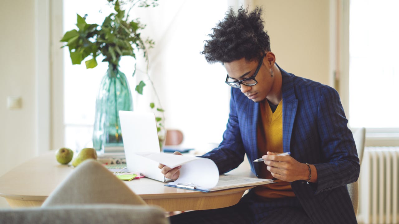 Young man is making a budget at home