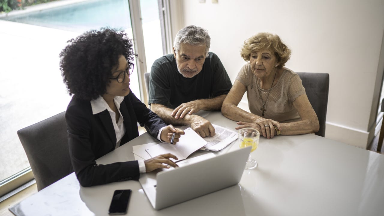 Financial advisor helping a senior couple at home