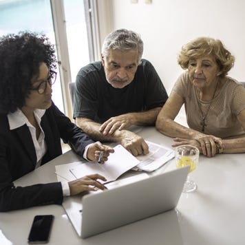 Financial advisor helping a senior couple at home