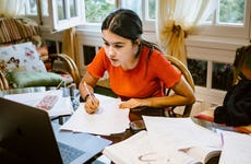 High school student works on homework at a desk