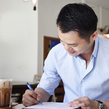 Business man reviewing paperwork in a cafe