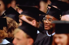 College student sits in crowd at graduation ceremony