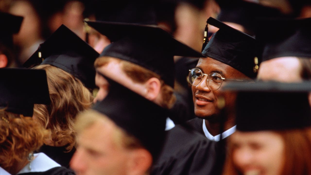College student sits in crowd at graduation ceremony