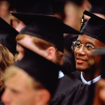 College student sits in crowd at graduation ceremony
