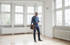 Man looking around in empty apartment