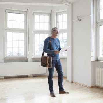 Man looking around in empty apartment