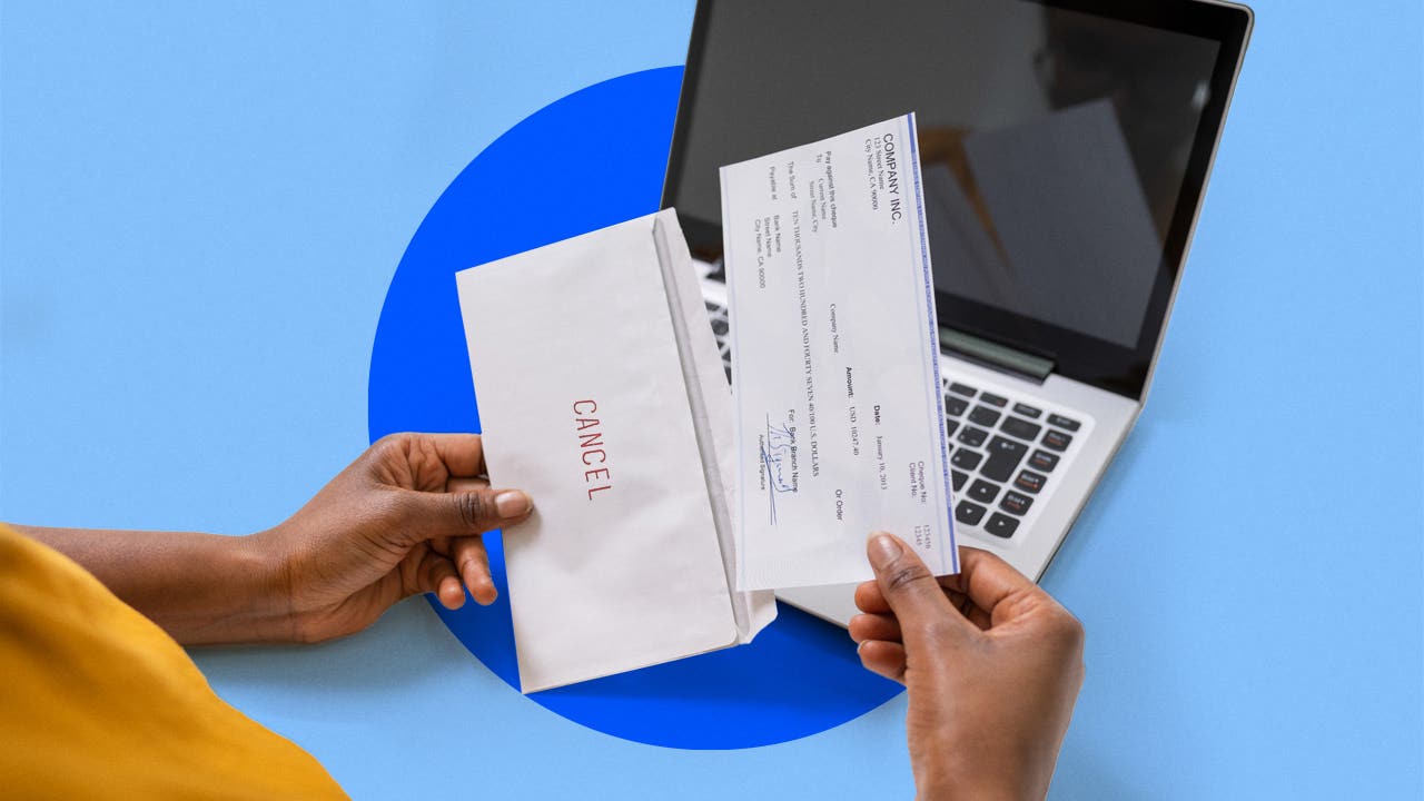 Woman putting a check in an envelope that says cancel