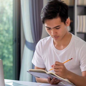 Man looks over notes in a notebook