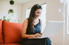 Woman working online on laptop at home