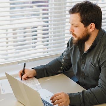 Man works on paperwork at a desk