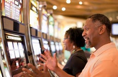 Couple playing slot machines at a casino