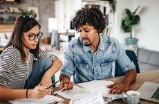 Multi-ethnic couple planning their home budget