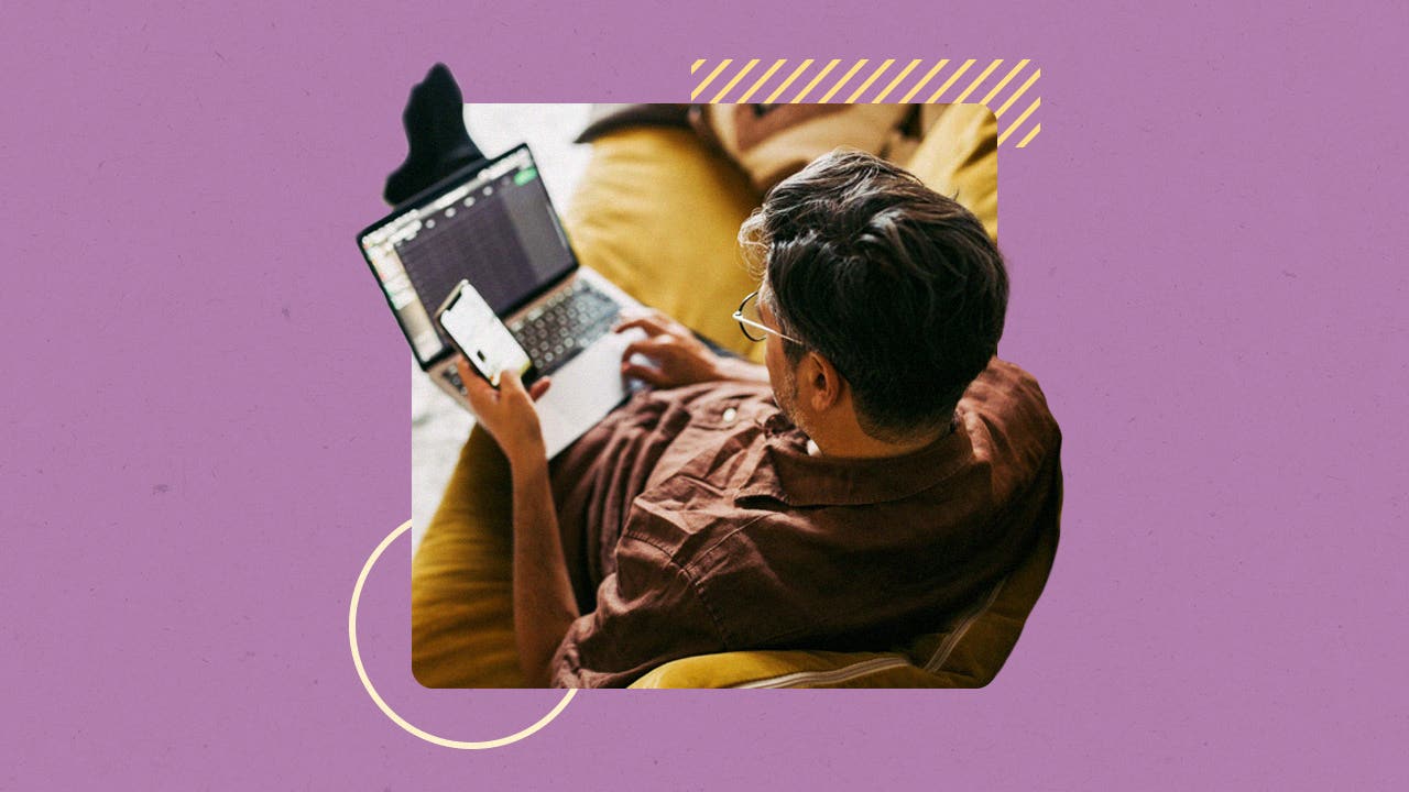 design image a man sitting down on a couch with a laptop in his lap and phone in one hand