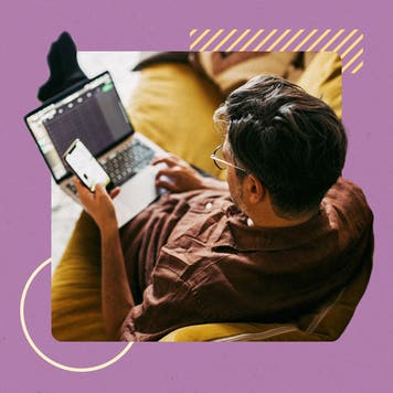 design image a man sitting down on a couch with a laptop in his lap and phone in one hand