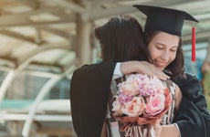 Mother and daughter hug at a college graduation