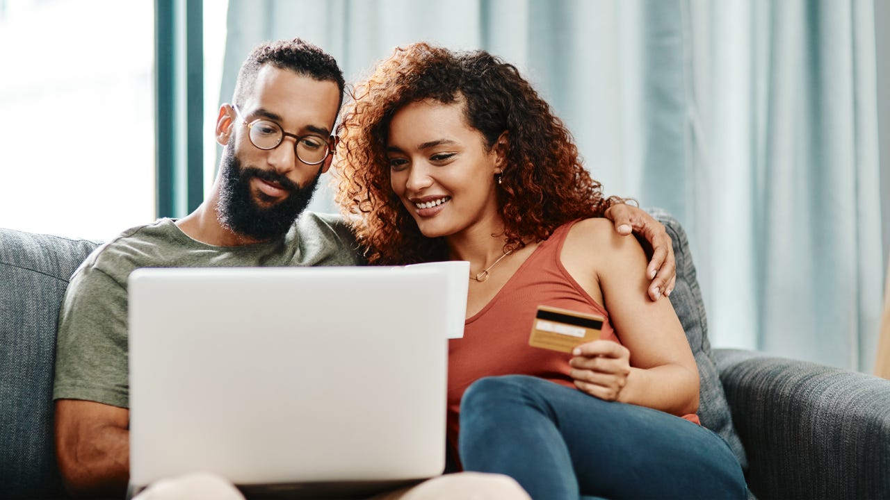 Couple looking at credit card offers online